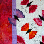 A closer look at the flower butterflies - even one flying off the quilt!